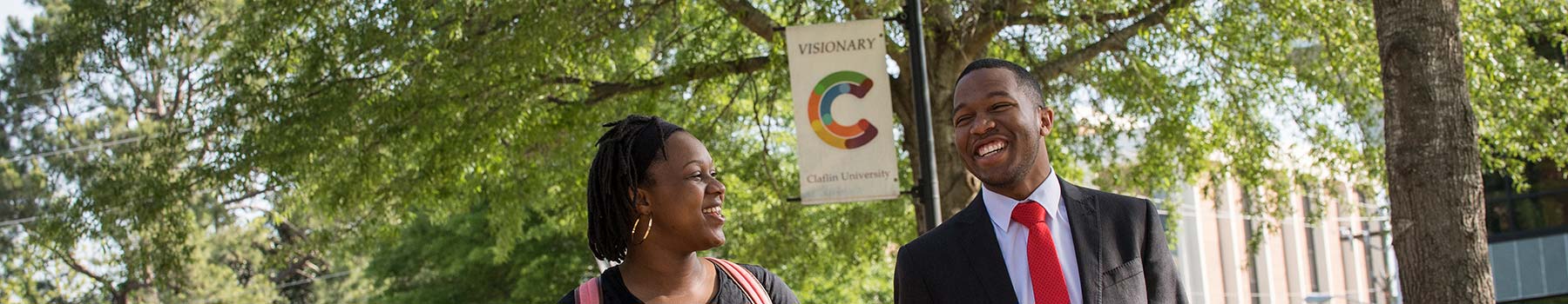 Two friendly students walking on campus